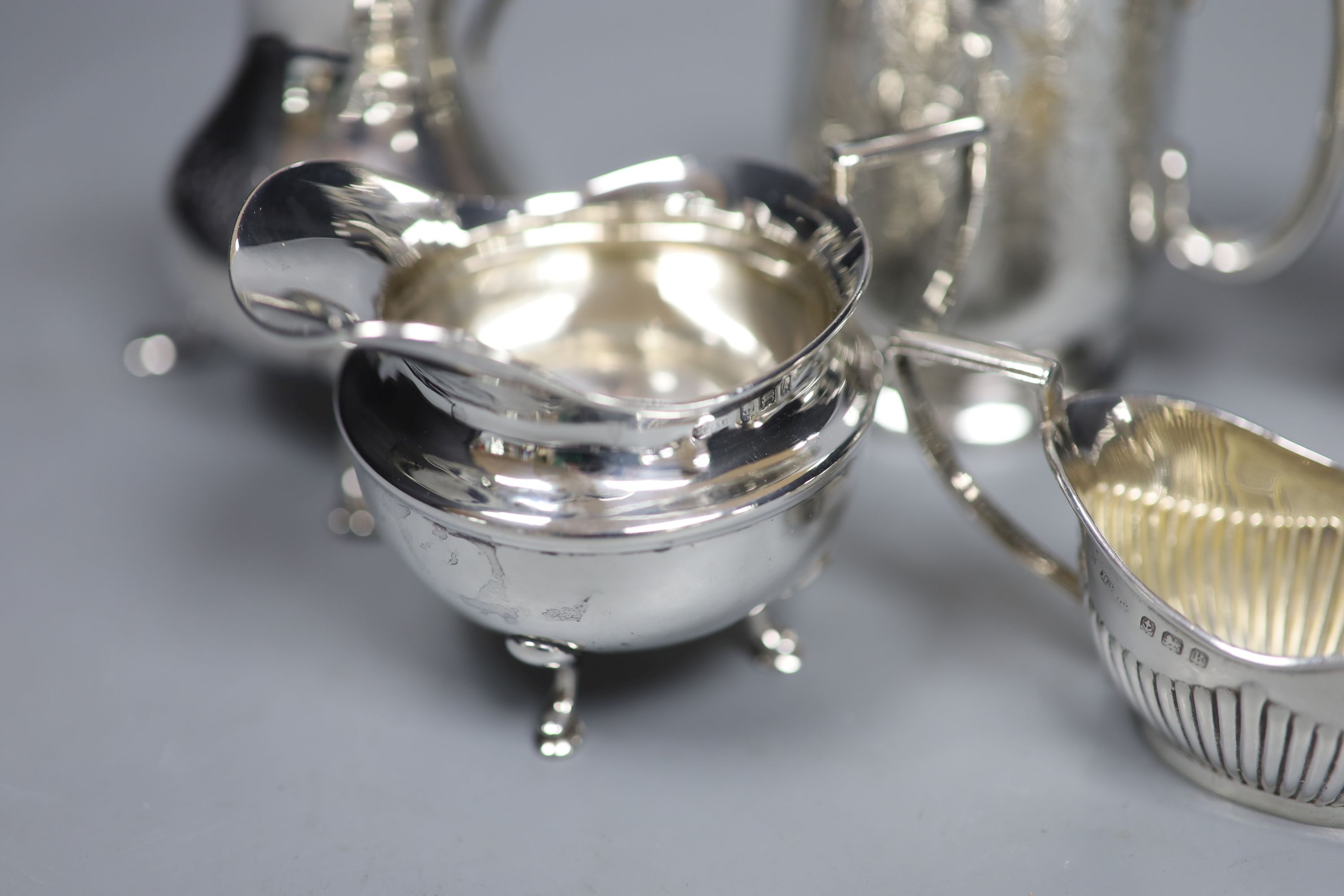 A Victorian engraved silver footed Christening mug and four silver cream jugs, various, 12.3 oz approx